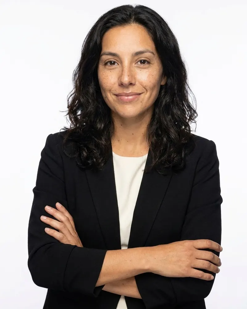 Confident stance with arms crossed on white