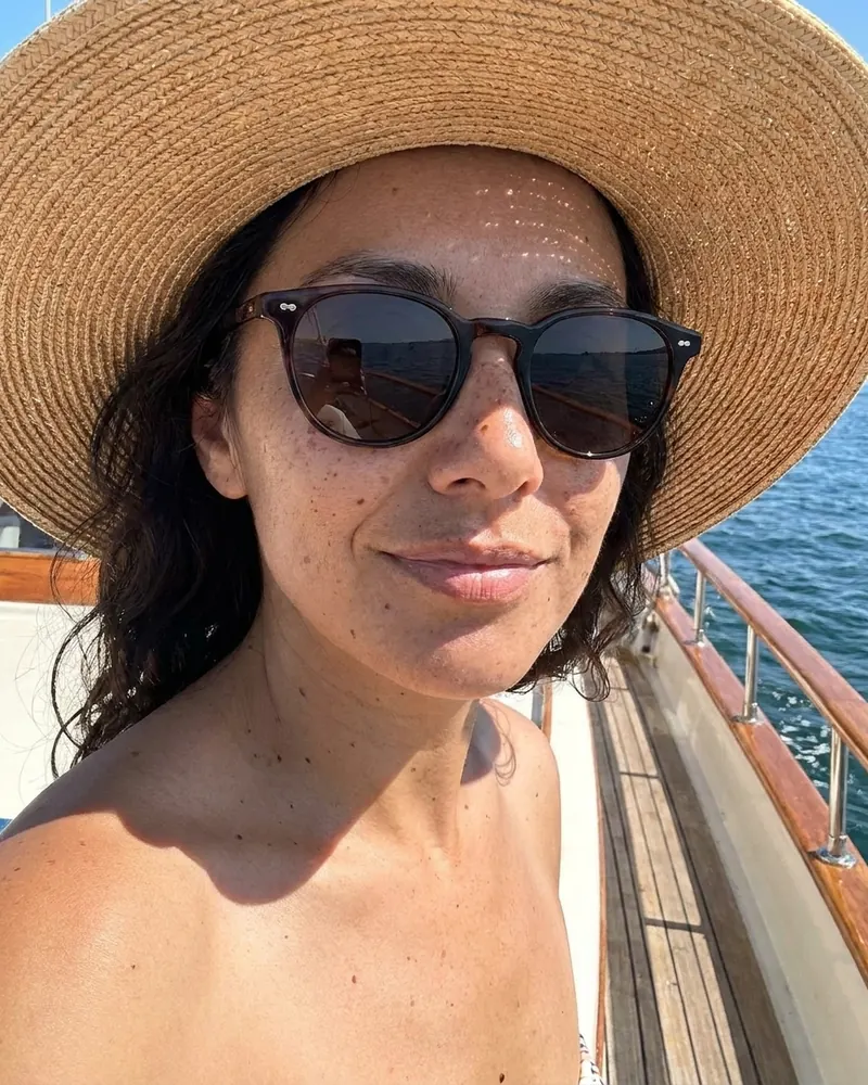 Sunglasses and a straw hat on a boat